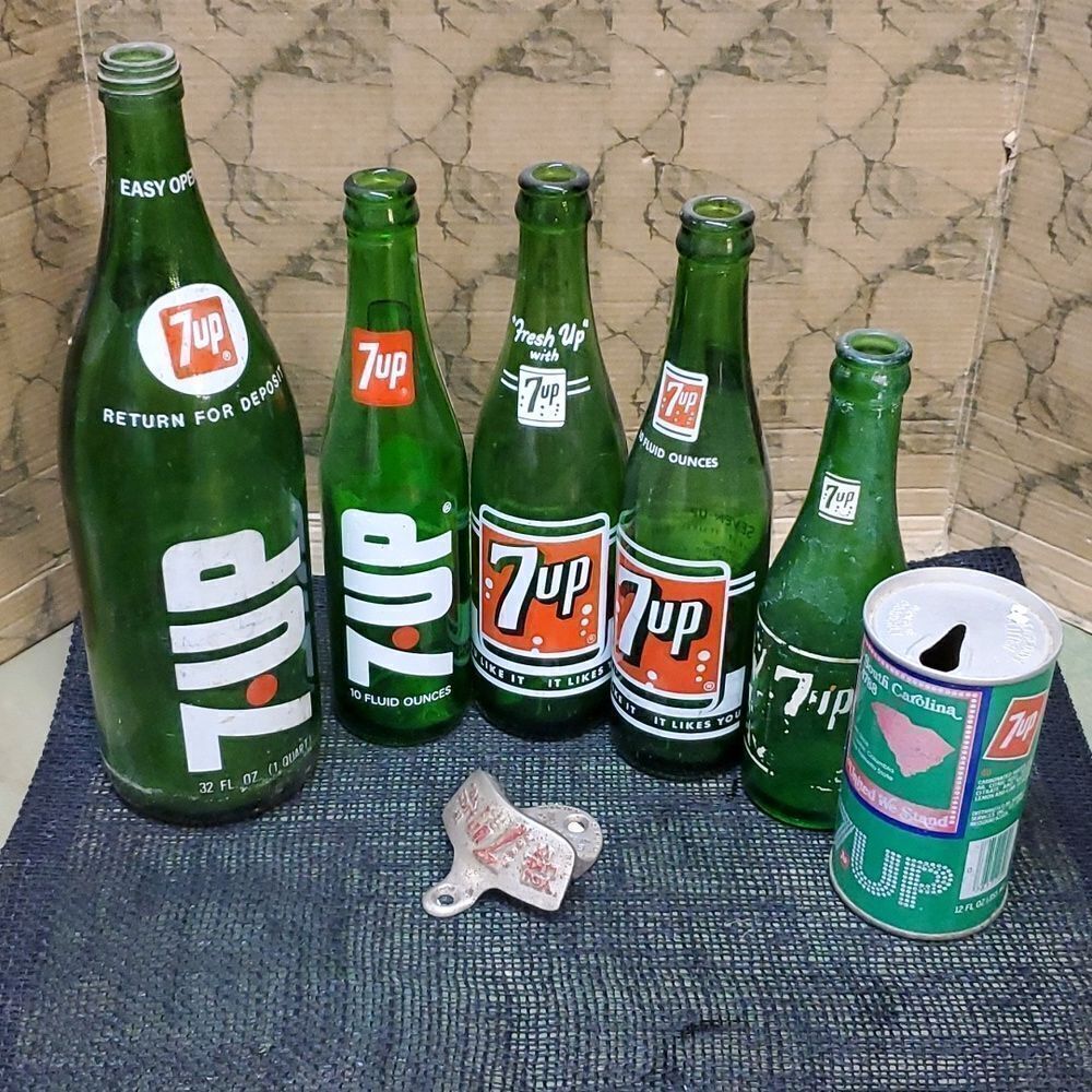 5 VINTAGE GLASS 7UP BOTTLES, 1 CAN AND ONE COOLER OPENER